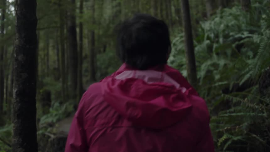 A woman walks in the woods