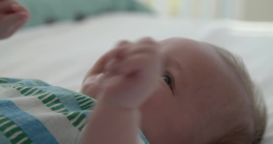 A baby laughing on the floor