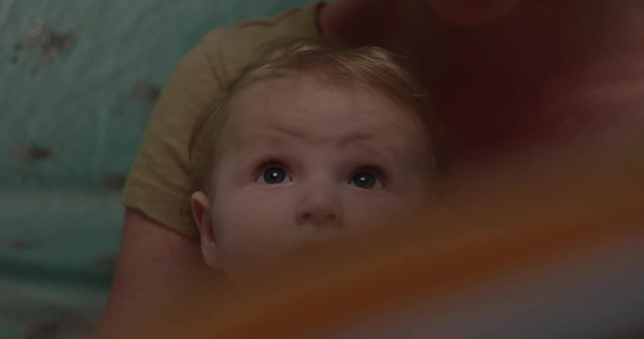 An adult holding a baby in their arms