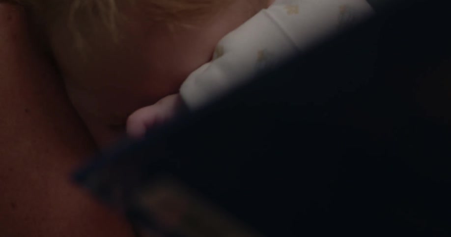 An adult holding a baby in their arms
