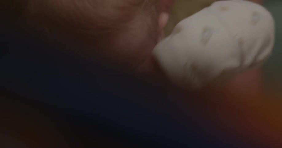 A baby rubs its eyes