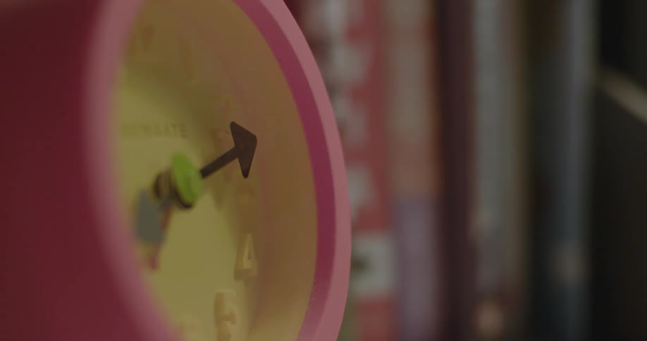 A pink and yellow childrens clock