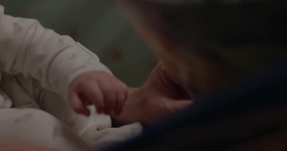An adult holding a baby in their arms