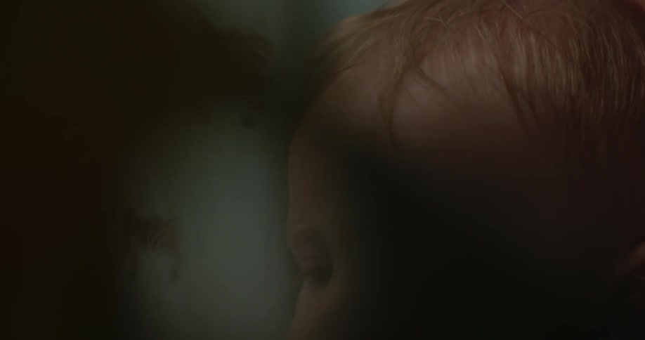A baby looks at a book