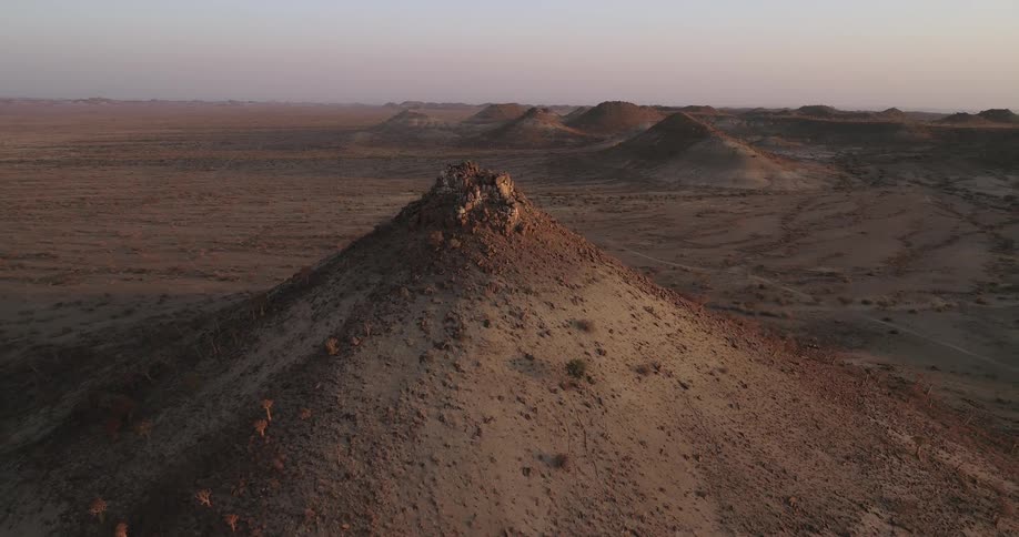 Ariel view of barren hills and plains during the day