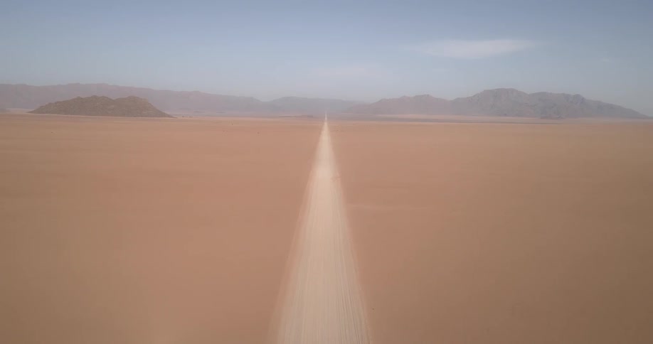 A desert with hills in the background