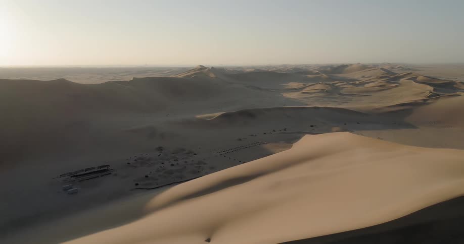 A desert with sand dunes and the sky in the background