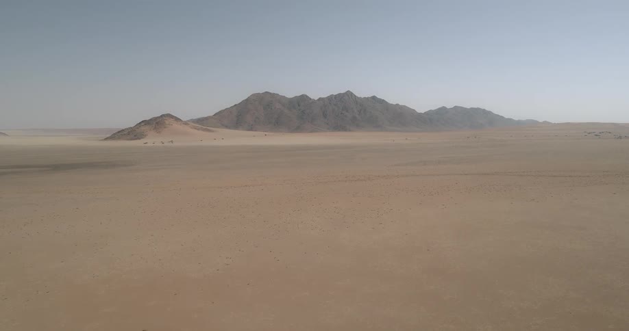 Mountains stand in the middle of a desert