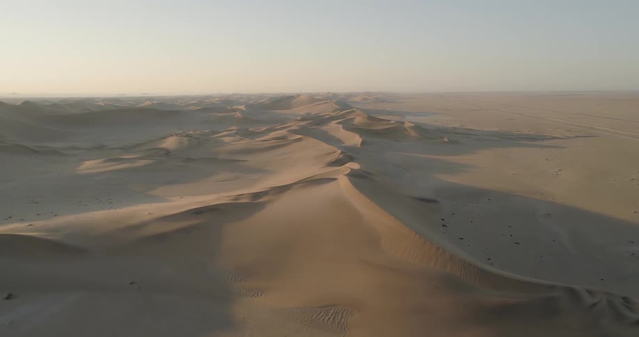 Aerial view of golden desert with sand dunes during the day