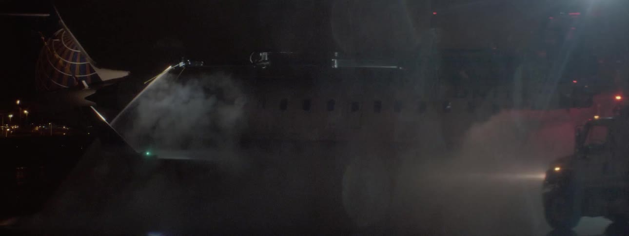 Lights flash on emergency vehicles and water is sprayed on to an object