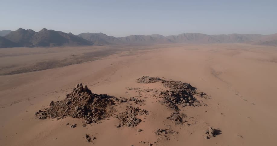 Aerial panoramic view of desert with mountains on horizon
