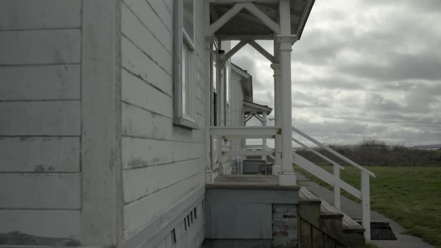 A couple of wooden houses are lined up on a cloudy day
