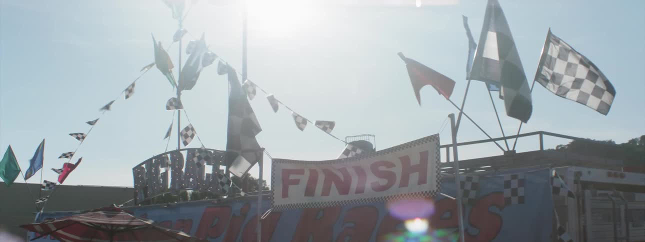 A finish line marked with chequered flags and bunting