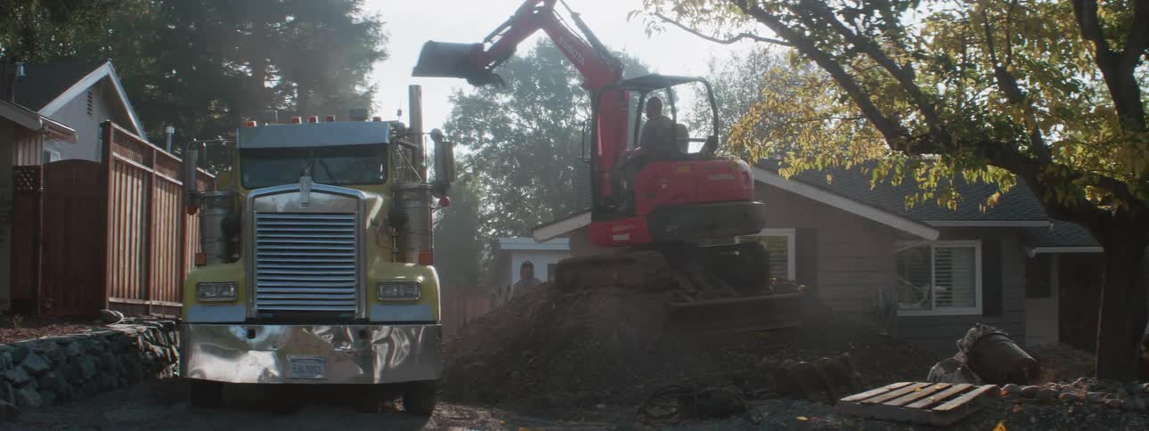 A person is working construction outdoors