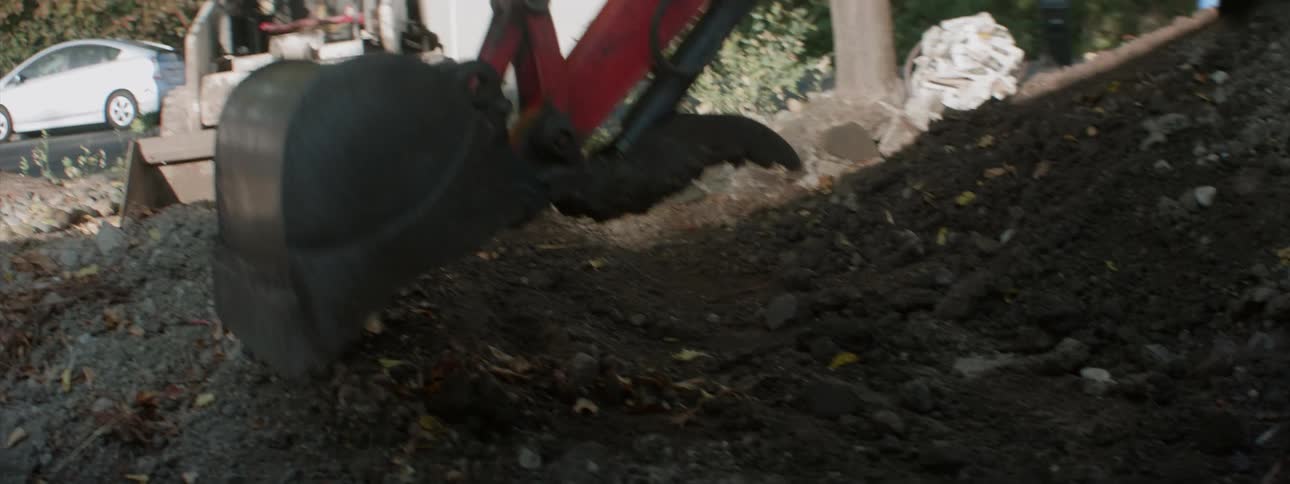 Landscaping equipment moves dirt