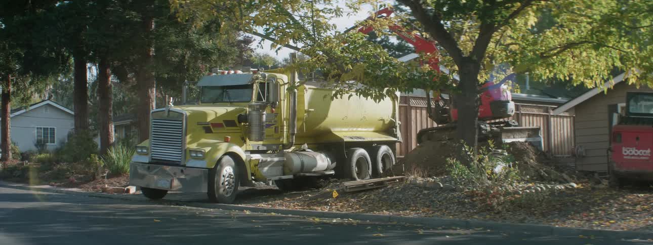 A truck backing into a construction site