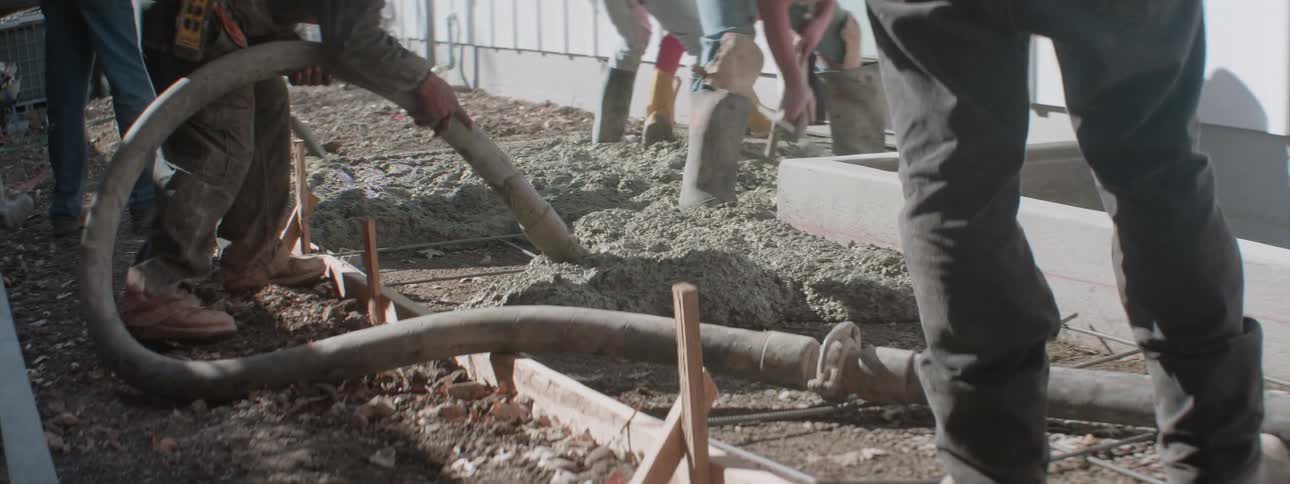 The people are working laying cement