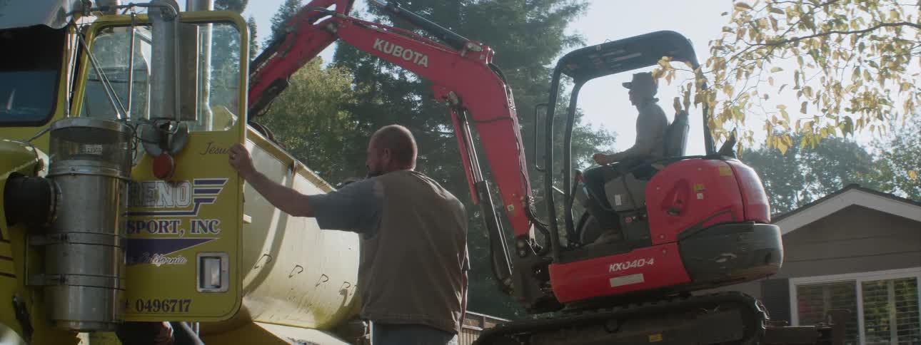 Workers on a job site with heavy construction equipment