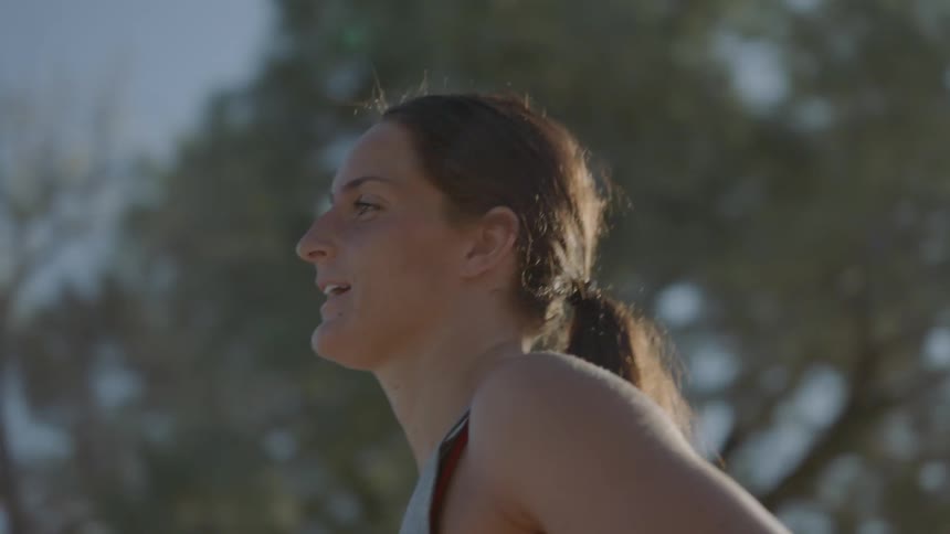 A woman is jogging outdoors