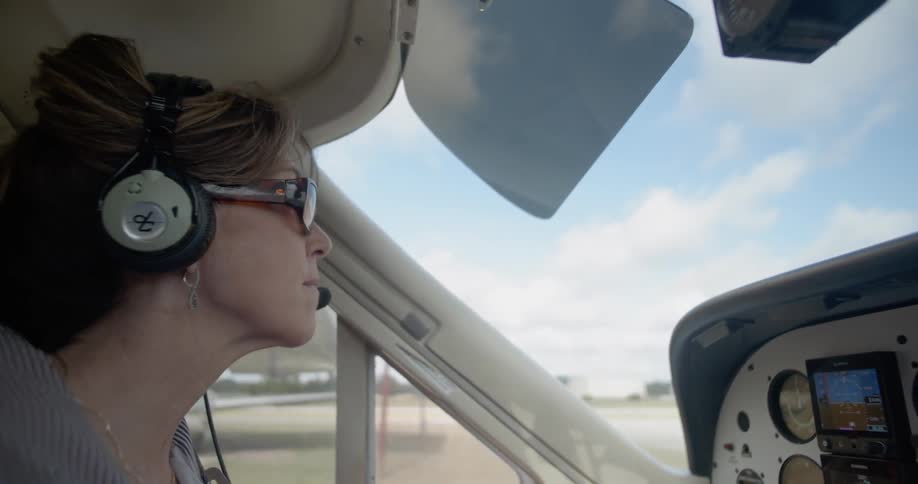 A woman is steering the plane as it turns