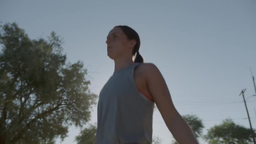 A woman jumps rope outside