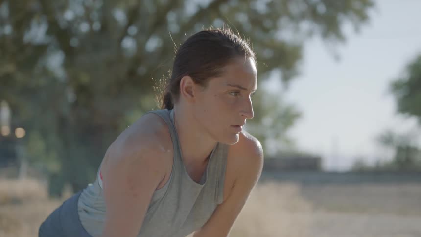 A woman readies herself for racing as a train passes by