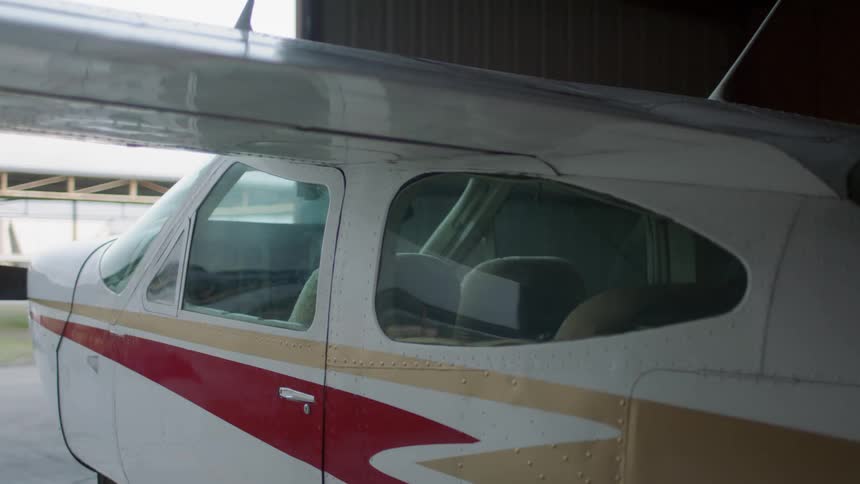A man opens a door in a building with an airplane