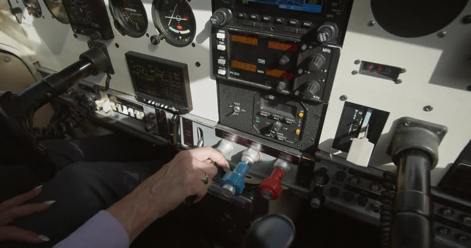 A white woman controls an airplane