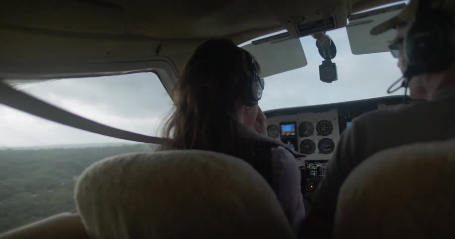 A man and woman sit in the front of the plane