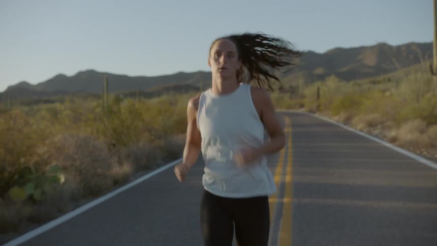 A woman runs down the road