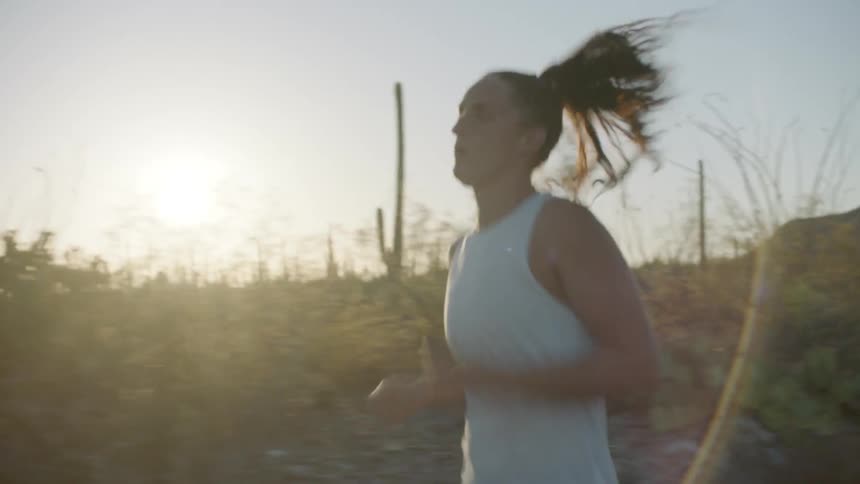 A woman runs through the desert