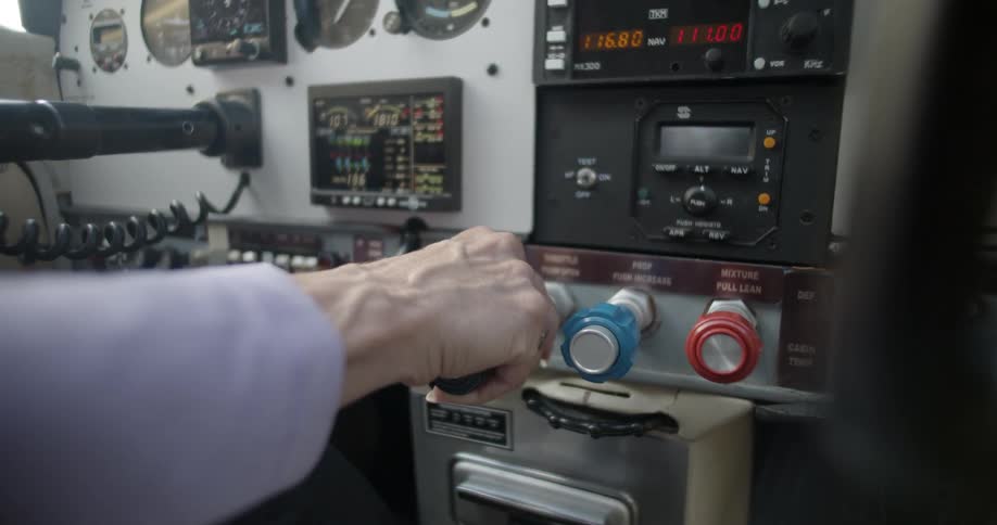 A persons hand touching controls on a machine