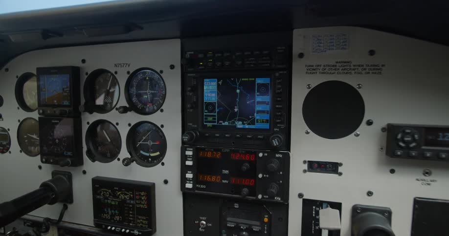 A screen is illuminated on a dash covered in instrument gauges