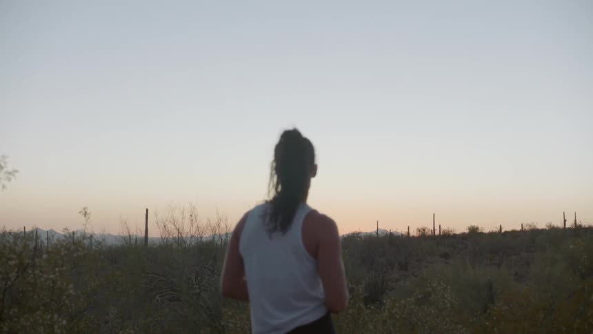 Shot of a woman looking towards the sunset