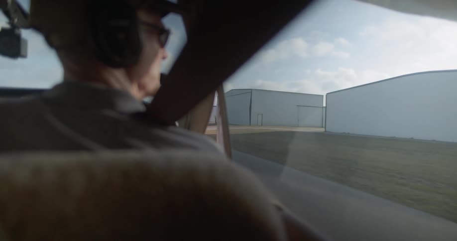A person taxis a plane at an airport