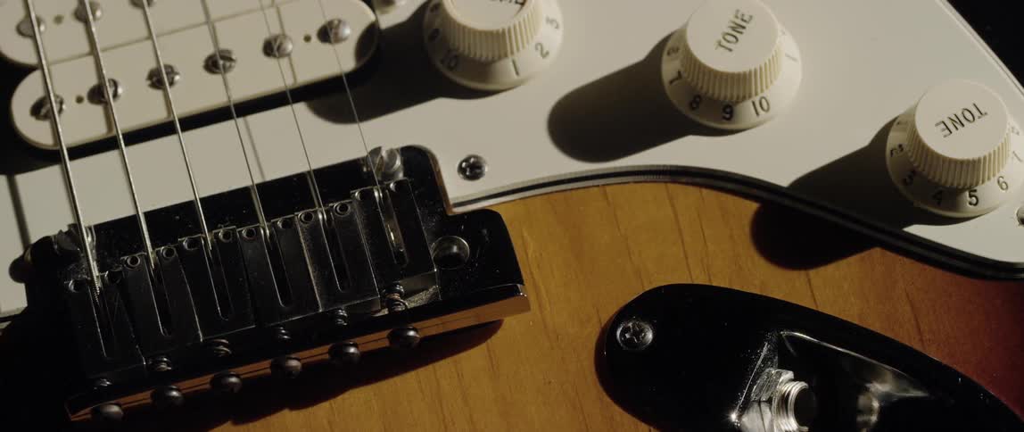 A close up view of a guitar bridge