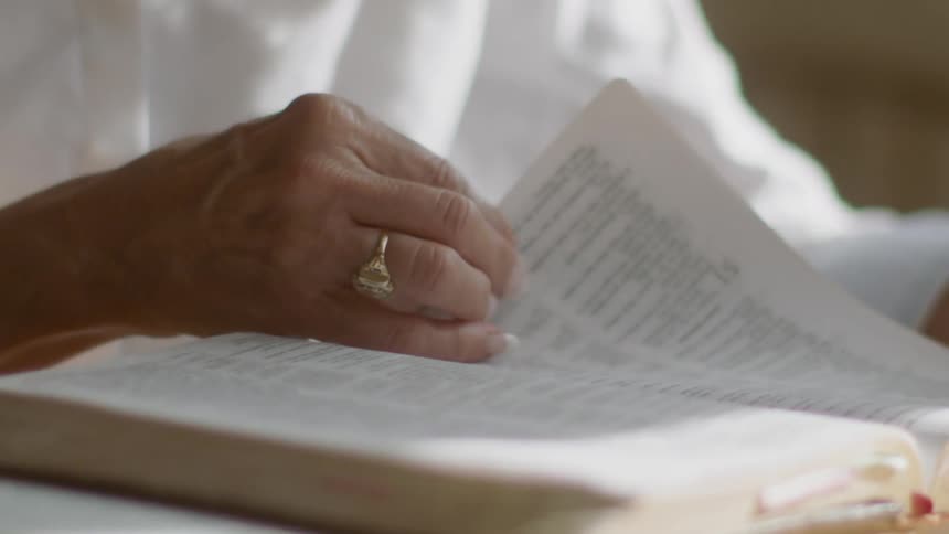 A woman is reading a book indoors