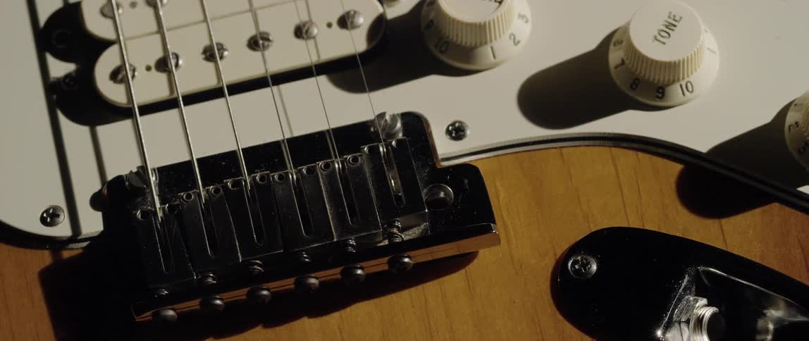 The bridge pick guard and pickups of a guitar
