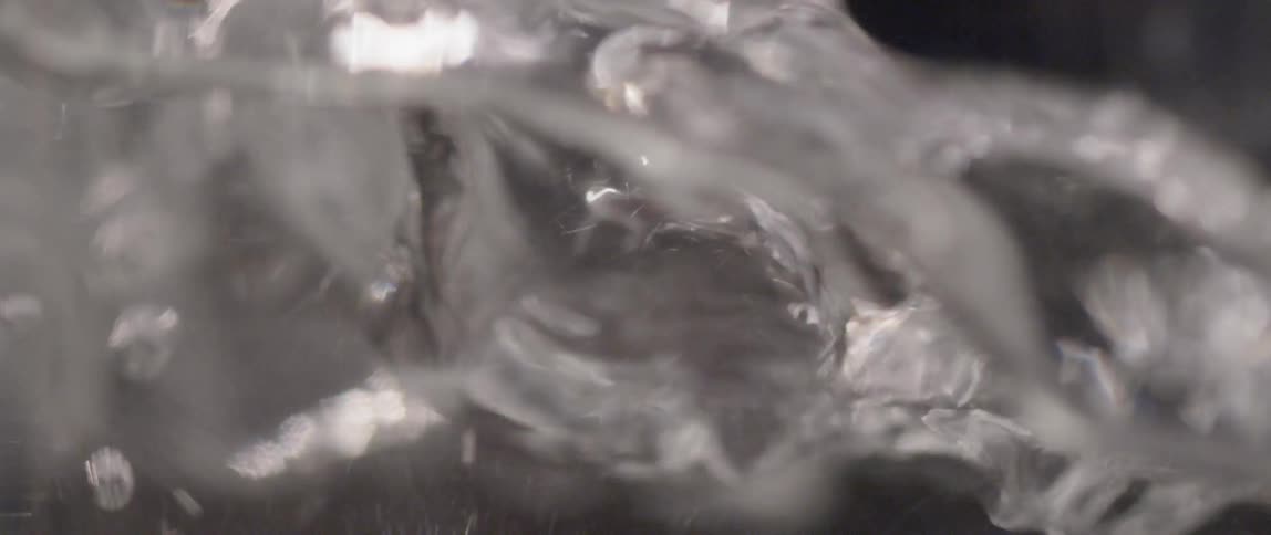 Water splashing and bubble in a clear container