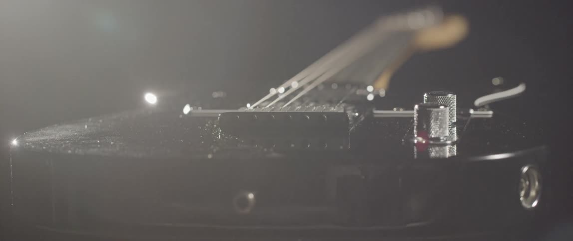 Close up of black electric guitar
