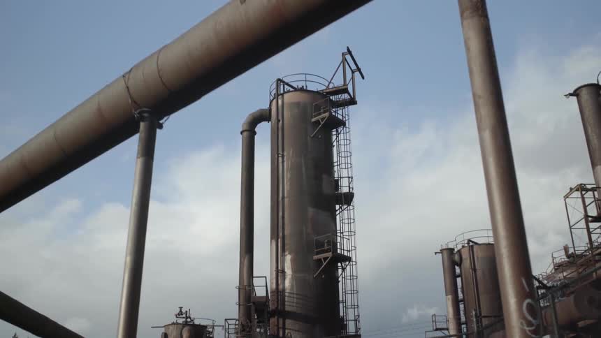 An industrial tower against a cloudy sky