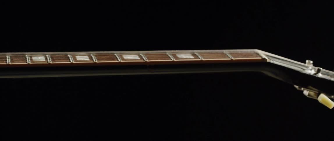 Display of an acoustic guitar neck fretboard