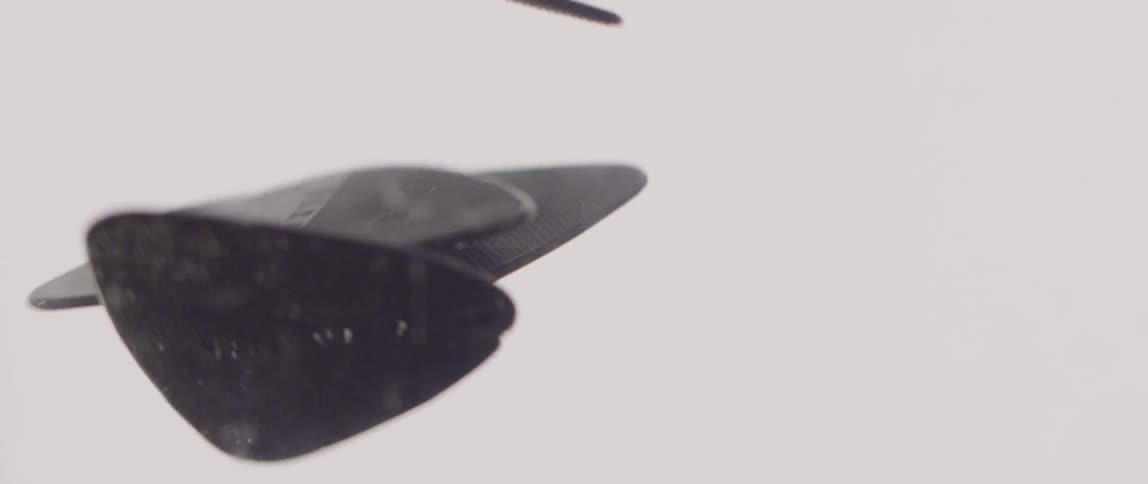 Guitar picks slowly floating down after being dropped in water
