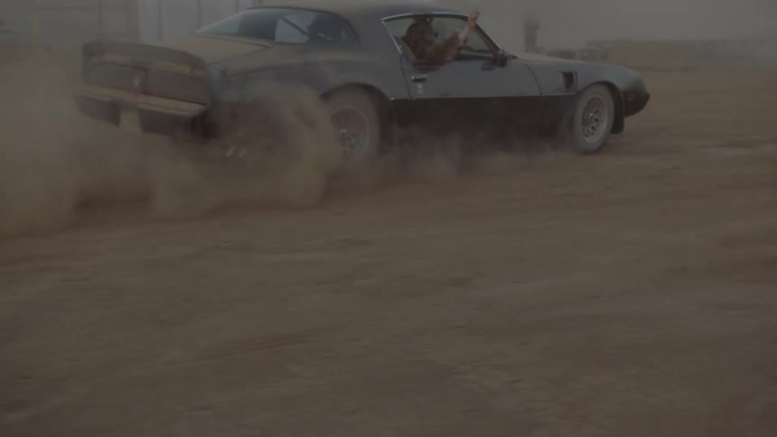 A car driving around on a dirt field