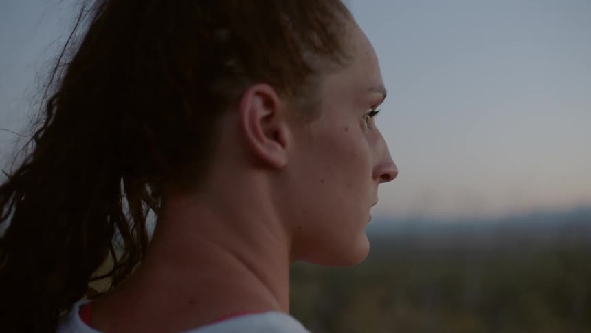 A young woman looks out to the distance