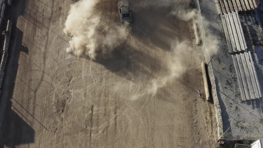 A car spins around in an arena of dirt