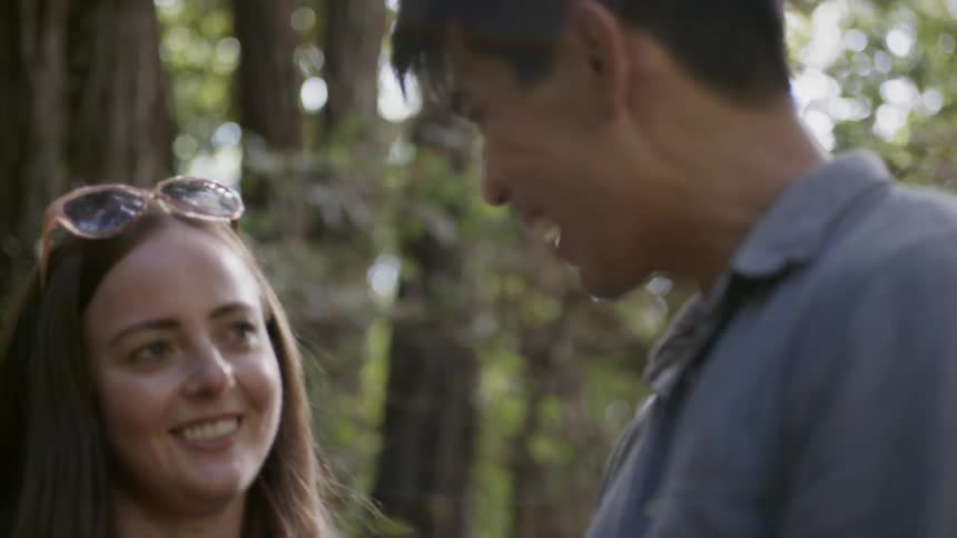 A man and woman talk and laugh together