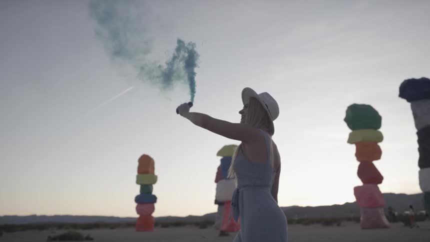 A young girl spins and releases powder from a tube