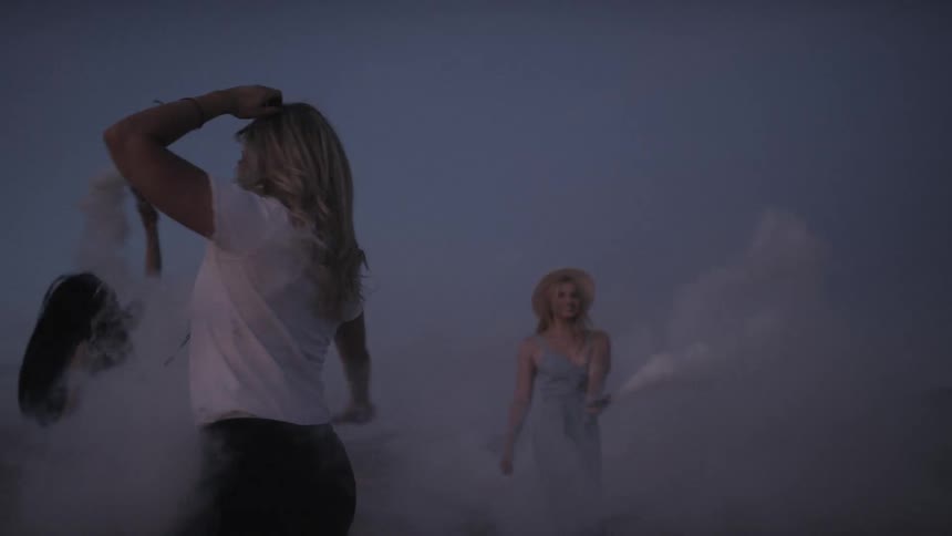 Women are dancing outdoors at night