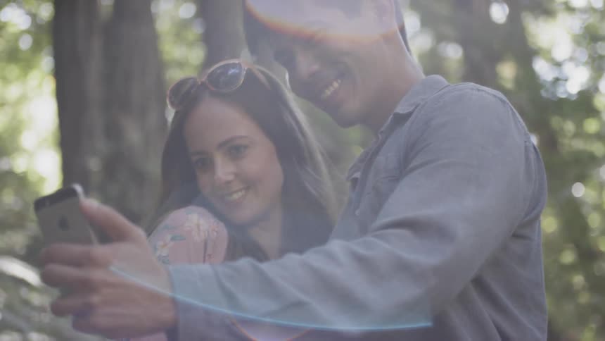 Couple take selfie among trees